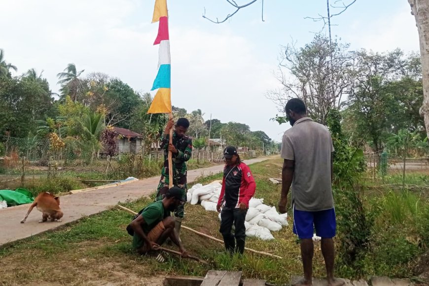 Sambut HUT ke-81 RI, Personel Satgas TMMD dan Warga Wanam Gotong Royong Pasang Bendera